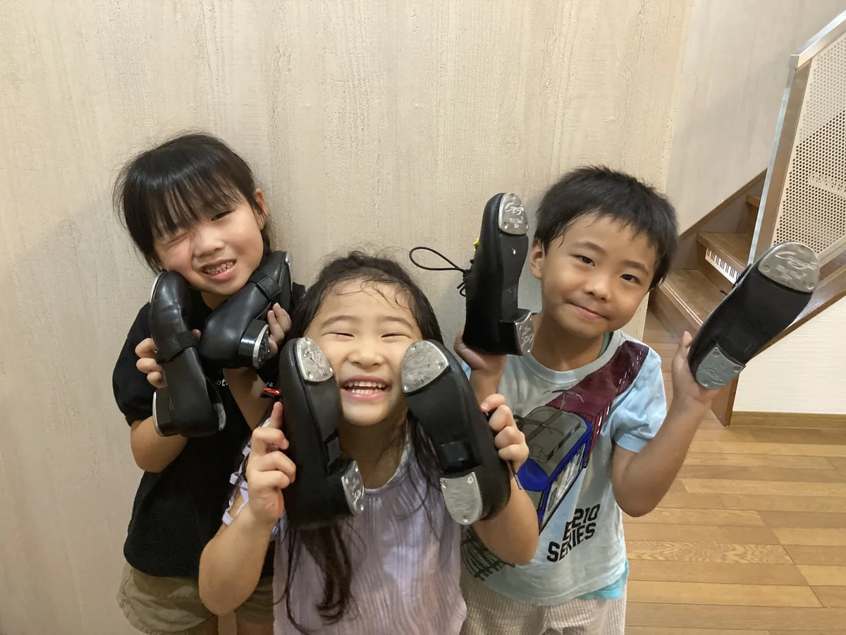 タップシューズを手に笑顔を見せる子どもたち